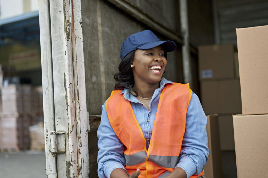 Female truck driver enjoying financial health with support of a workplace savings account