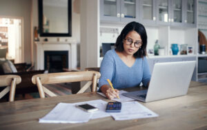 Shot of a young woman using a laptop to her employee benefit Brightside Financial Care