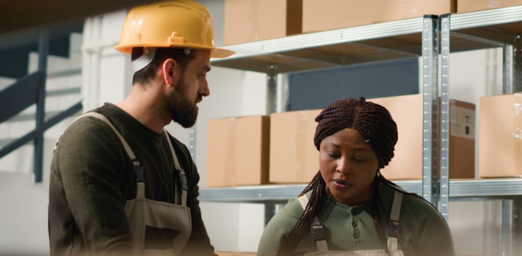 Two frontline employees working in a fulfillment center