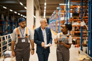 Frontline workers meet with their supervisor in a distribution center