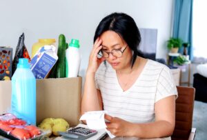Woman struggles with the cost of basic needs so is unable to get help from her employers' traditional financial wellness benefit.