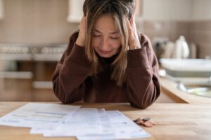 Woman struggles with mental health issues brought on by financial stress